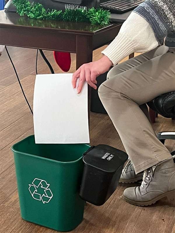 A person recycling paper