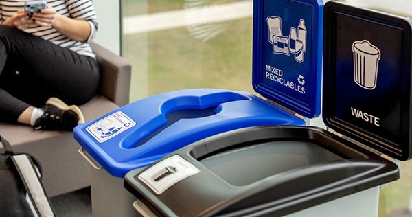 A set of trash and recycling bins