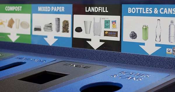 A well labeled trash and recycling system