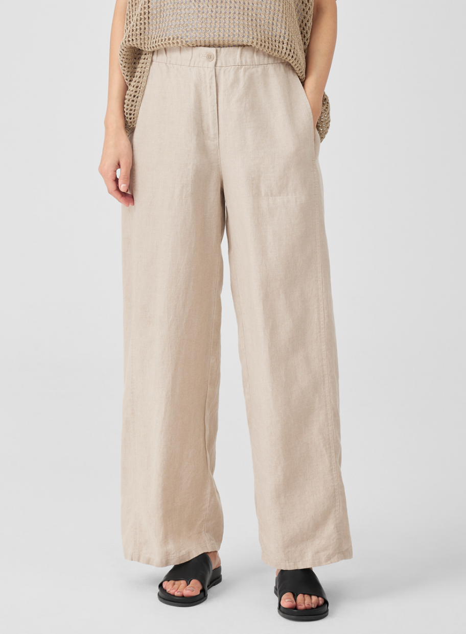 A model's legs, wearing khaki loose-fitting linen pants. 