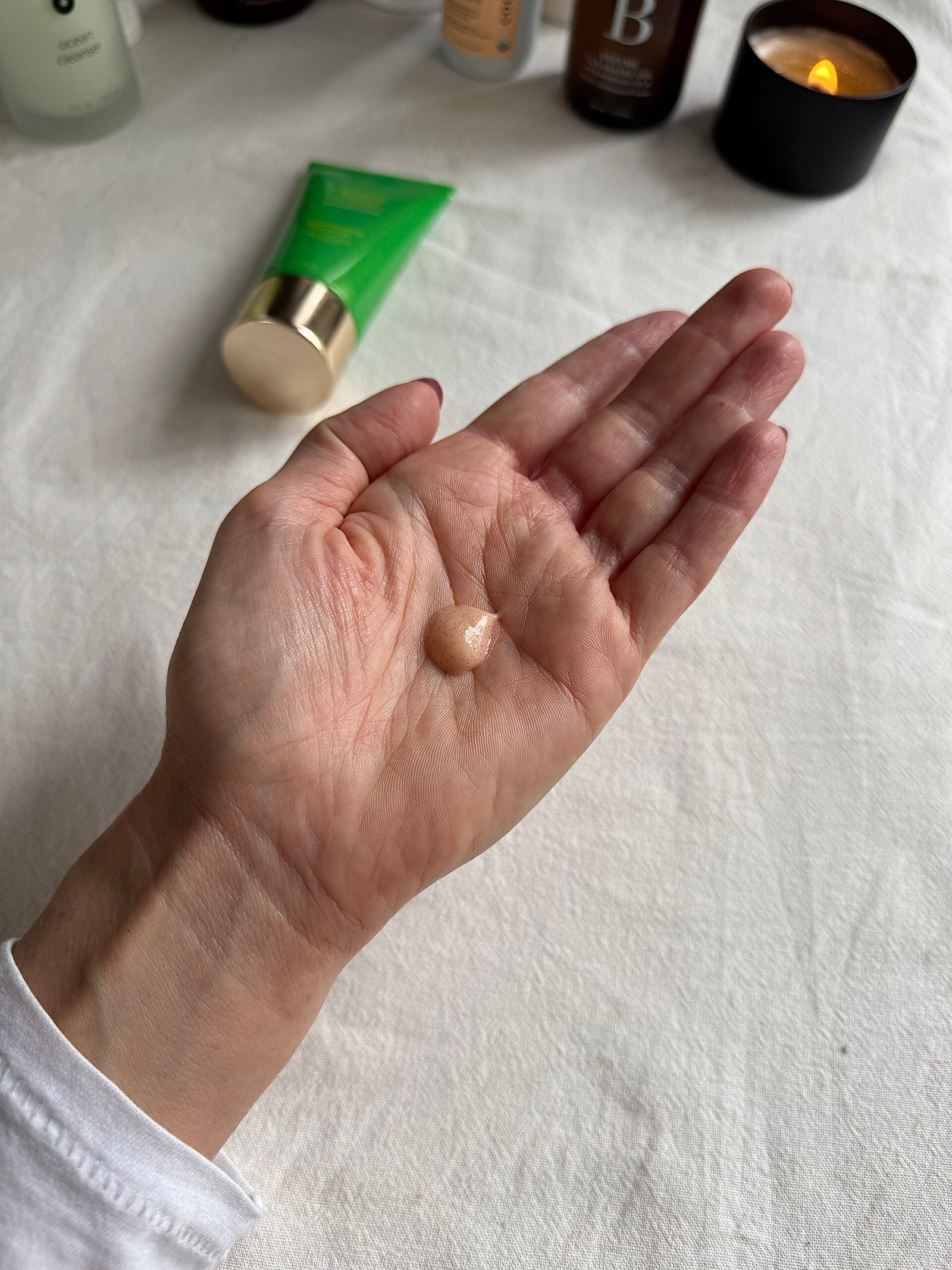 A hand with a small amount of Tata Harper face wash in the palm.