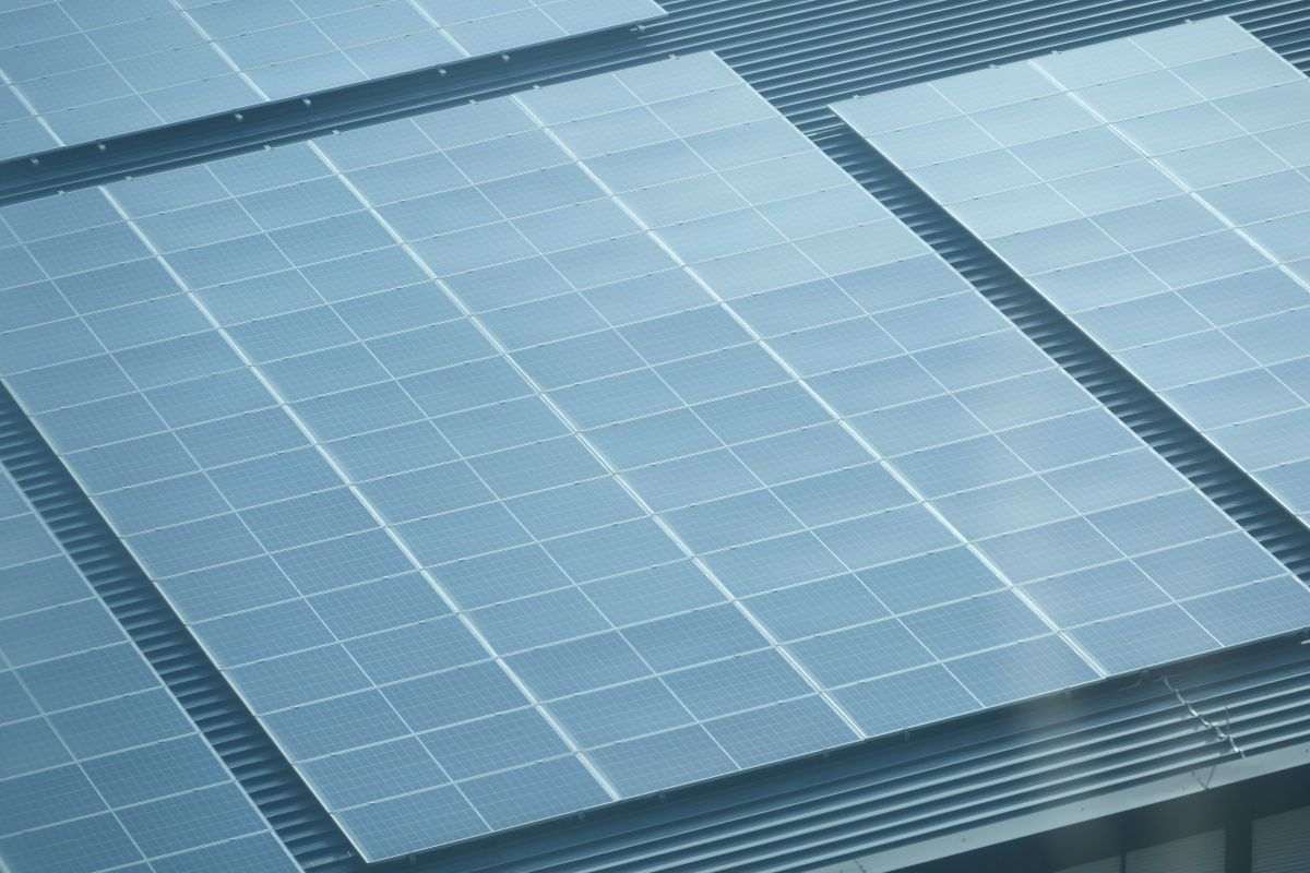 Aerial view of a rooftop covered with solar panels on a commercial building in Faridabad