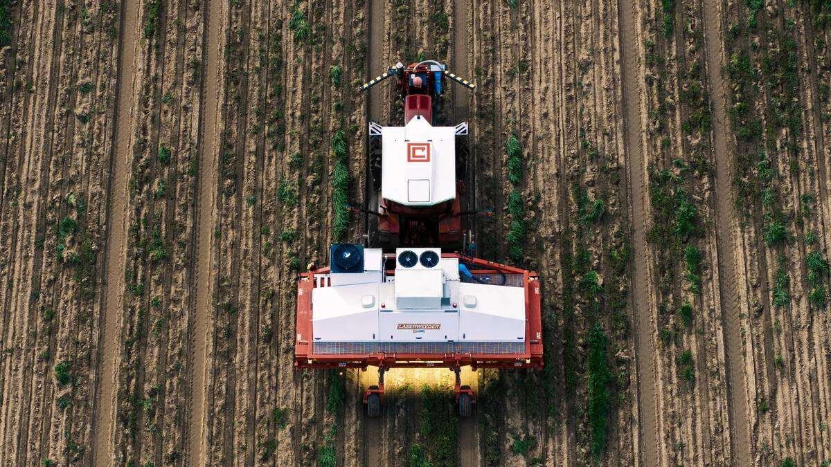 A tractor outfitted with the Carbon ATK autonomous retrofit system pulls a weed-blasting LaserWeeder. Both machines are manufactured by Carbon Robotics, located in Seattle, Washington. Photo: Carbon Robotics