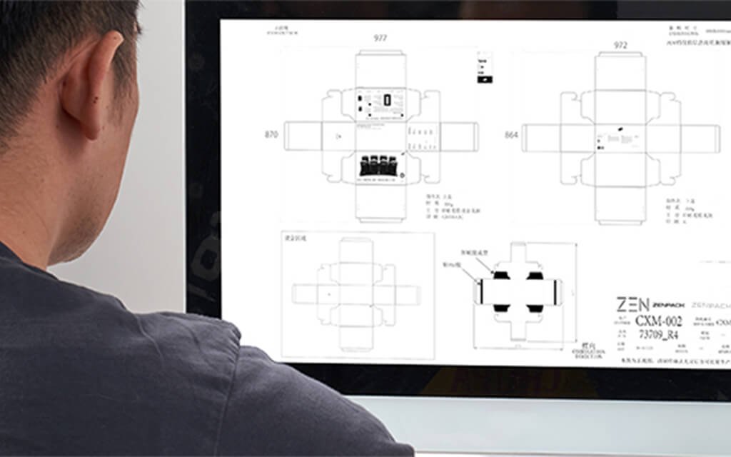 Designer reviewing dieline layout on computer screen