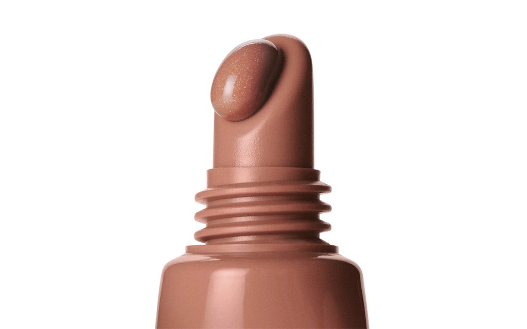 Rhode lip gloss packaging with a geometric cap and glossy applicator tip design.