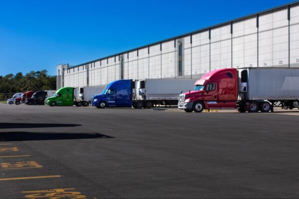 large trucks parked outside of a warehouse