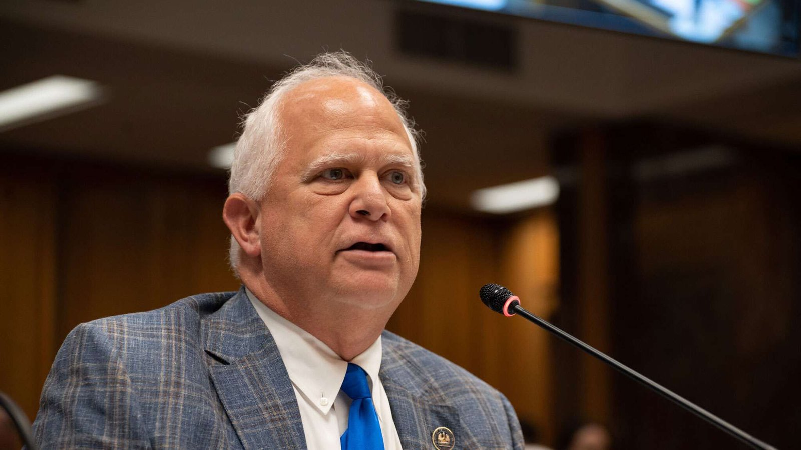Louisiana State Representative Charles "Chuck" Owen speaking into a microphone