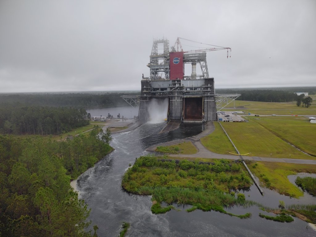 A drone view showing water flowing toward the Thad Cochran Test Stand as reservoir levels drop during the water‑removal process.