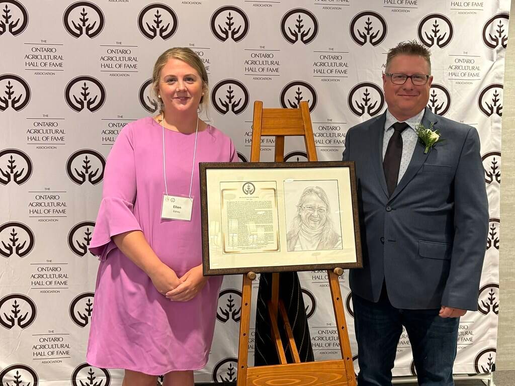 Board member Ellen Edney assists Mike Fisher in unveiling the portrait of Dr. Helen Fisher. Photo: Ontario Agricultural Hall of Fame