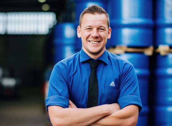 A man smiles because he has successfully submitted a hazardous waste reduction plan.