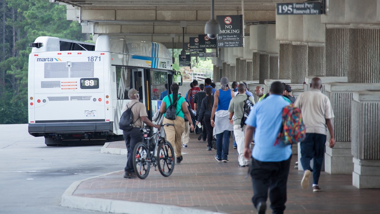 Commuters board a public transit bus in Atlanta.