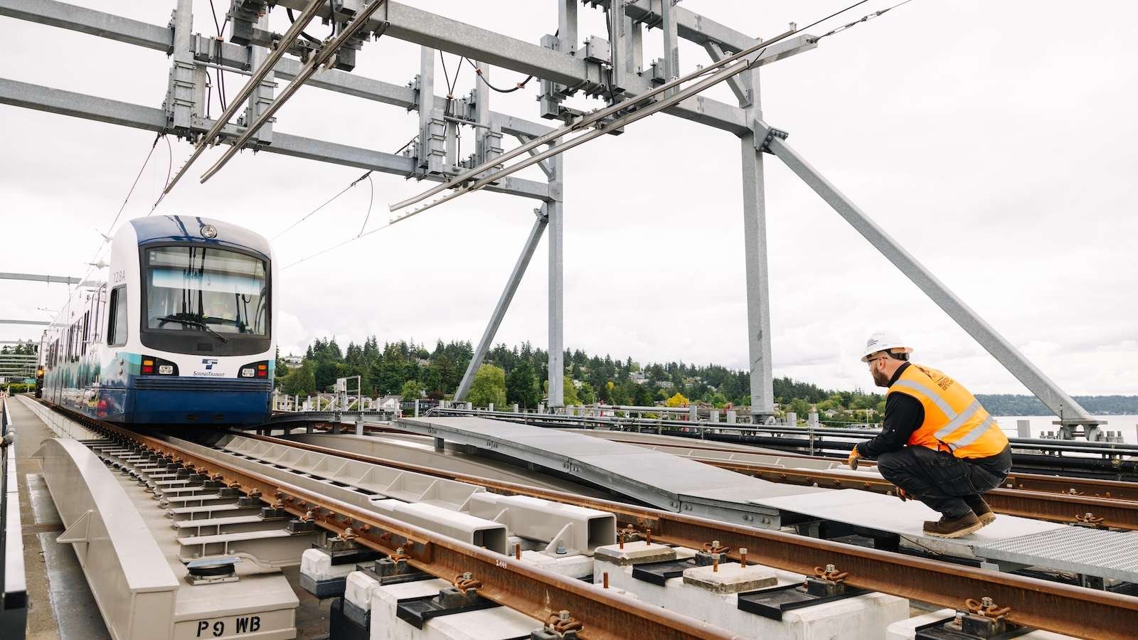 An unmanned light rail car s towed across a bridge to test a section of new track in Seattle.
