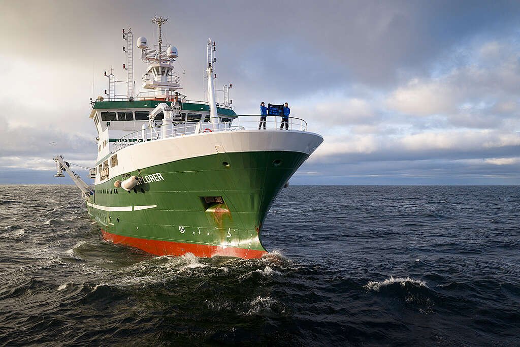 Dr. Sandra Schöttner, Greenpeace Science Lead, and Daniel Bengtsson, Communication Lead of the expedition, on the bow of the Deep Arctic Expedition research vessel in the Norwegian Sea.