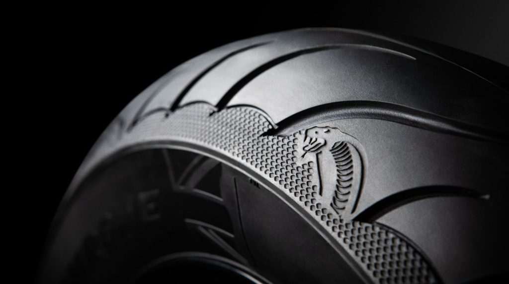 Close-up of the Cobra Chrome tire against a black background.