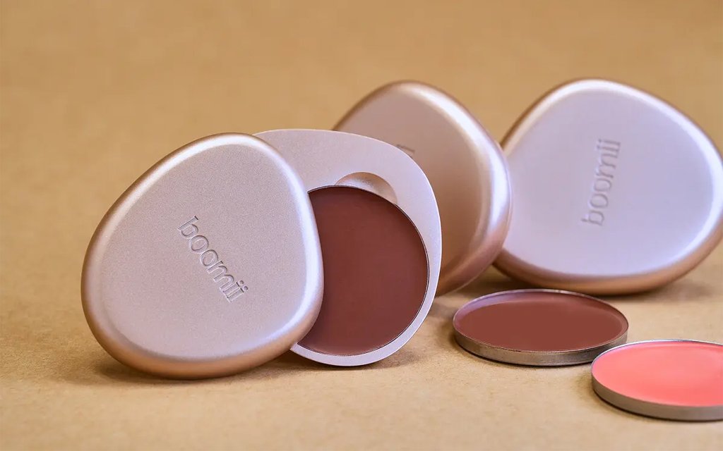 A product photo showcasing "Boomii" refillable cosmetics.