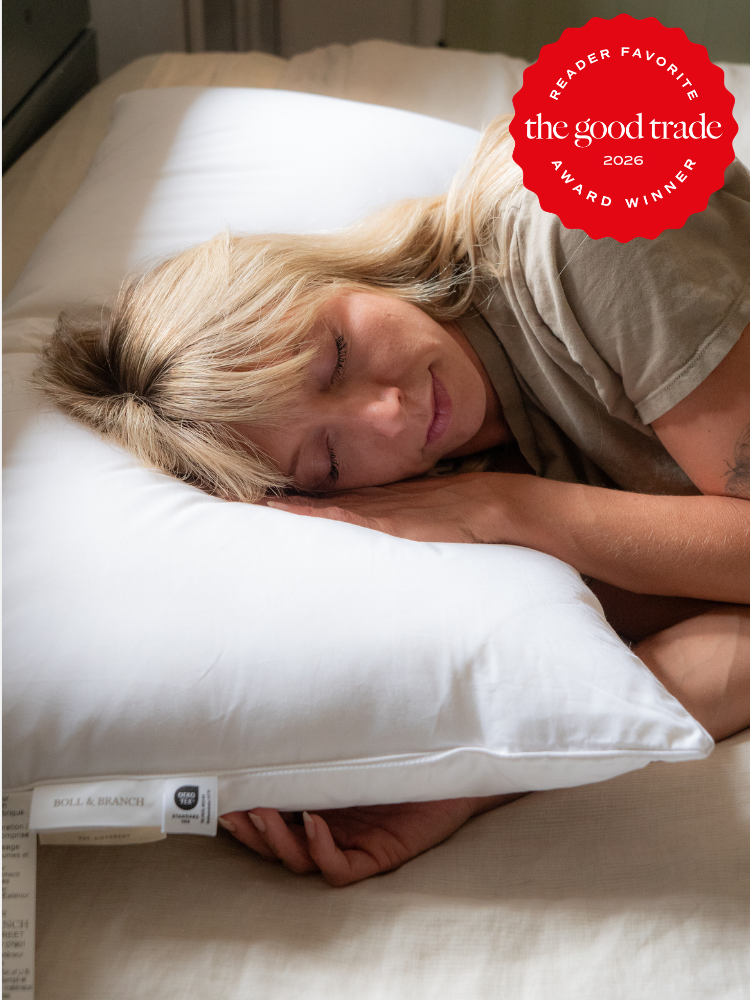 A person with blonde hair sleeps on a white pillow in a sunlit room. A red badge in the corner reads, “the good trade award winner, reader favorite 2026.”.