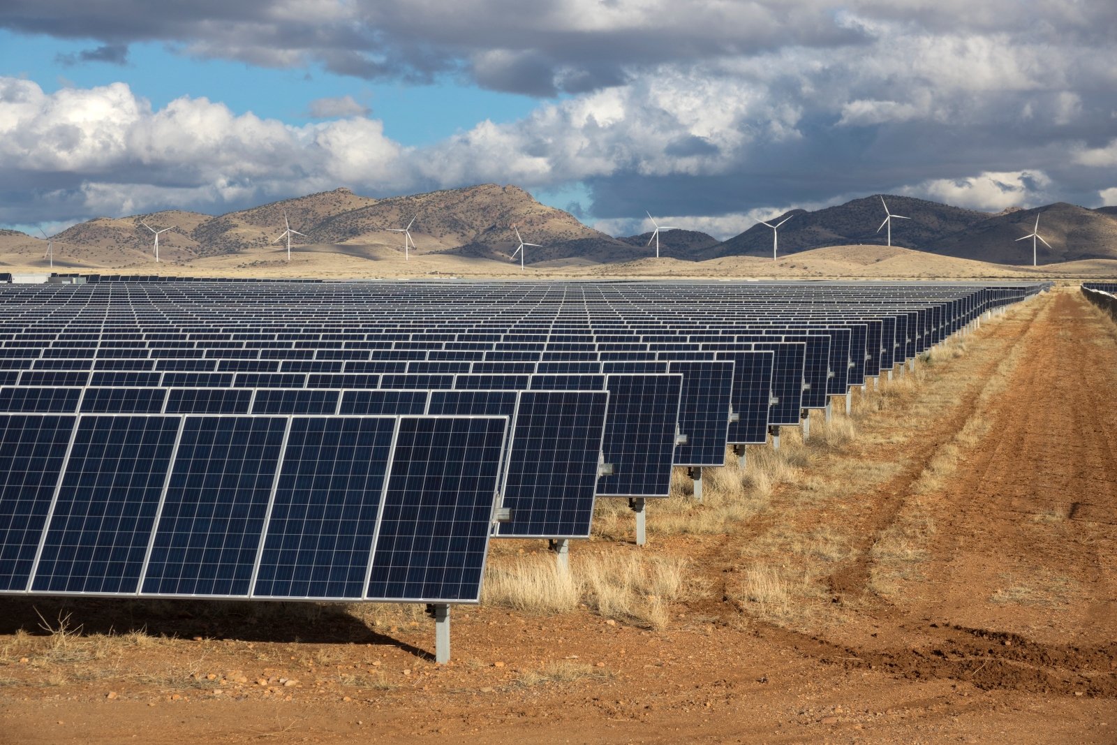 Solar panels and wind turbines in southern Arizona generate electricity for the city of Tucson. Both solar and wind have seen continued investment despite the repeal of the Inflation Reduction Act.