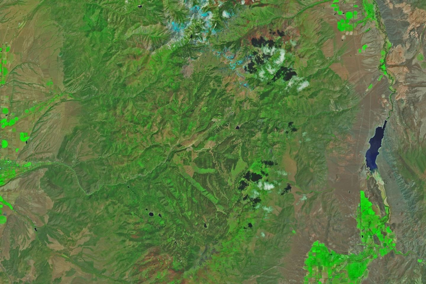 Mountainous landscapes appear green and untouched by fire in a satellite image acquired on June 5, 2026.
