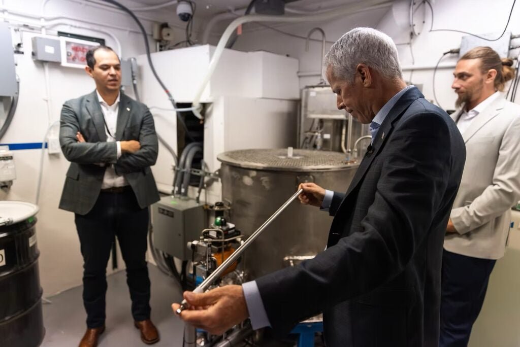 Secretary of Energy Chris Wright examines a fuel rod during a visit to Idaho National Laboratory, as part of preparations for Deployable Energy's demonstration reactor criticality test. Courtesy: Deployable Energy