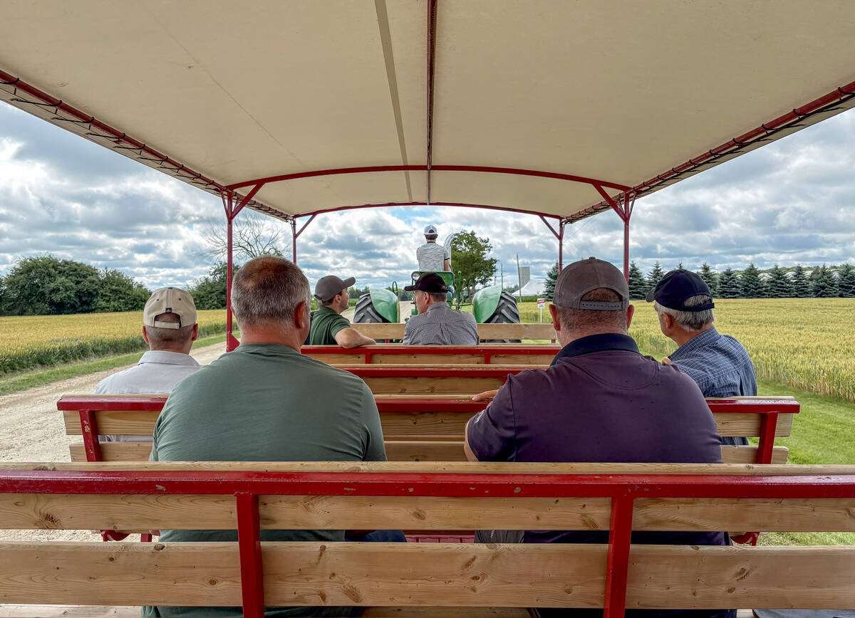 Folks chat on the wagon ride to Carlotte Farms to learn more about manure management, water-taking regulations, and the 360 Rain autonomous irrigation system at the Grand River Robotics demonstration day near Arthur, Ont., on July 10, 2026. Photo: Diana Martin