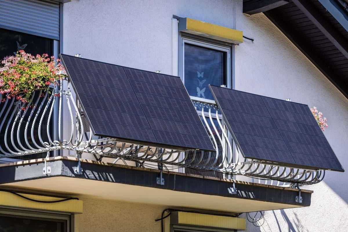 Solar panels mounted on the exterior of a residential home balcony