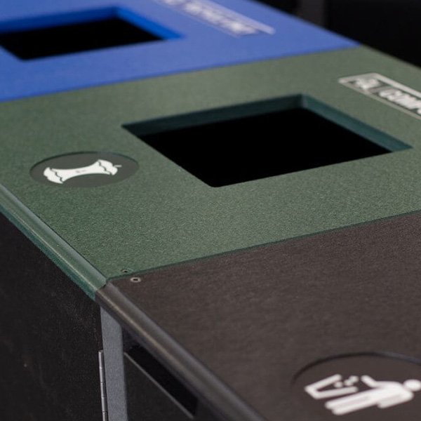 A three stream waste bin with recycling, compost, and trash lids
