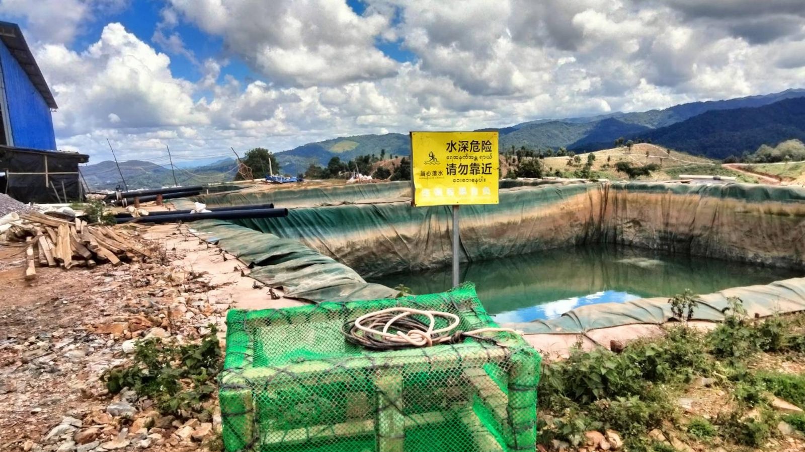 A yellow sign marks a rare earth mining site