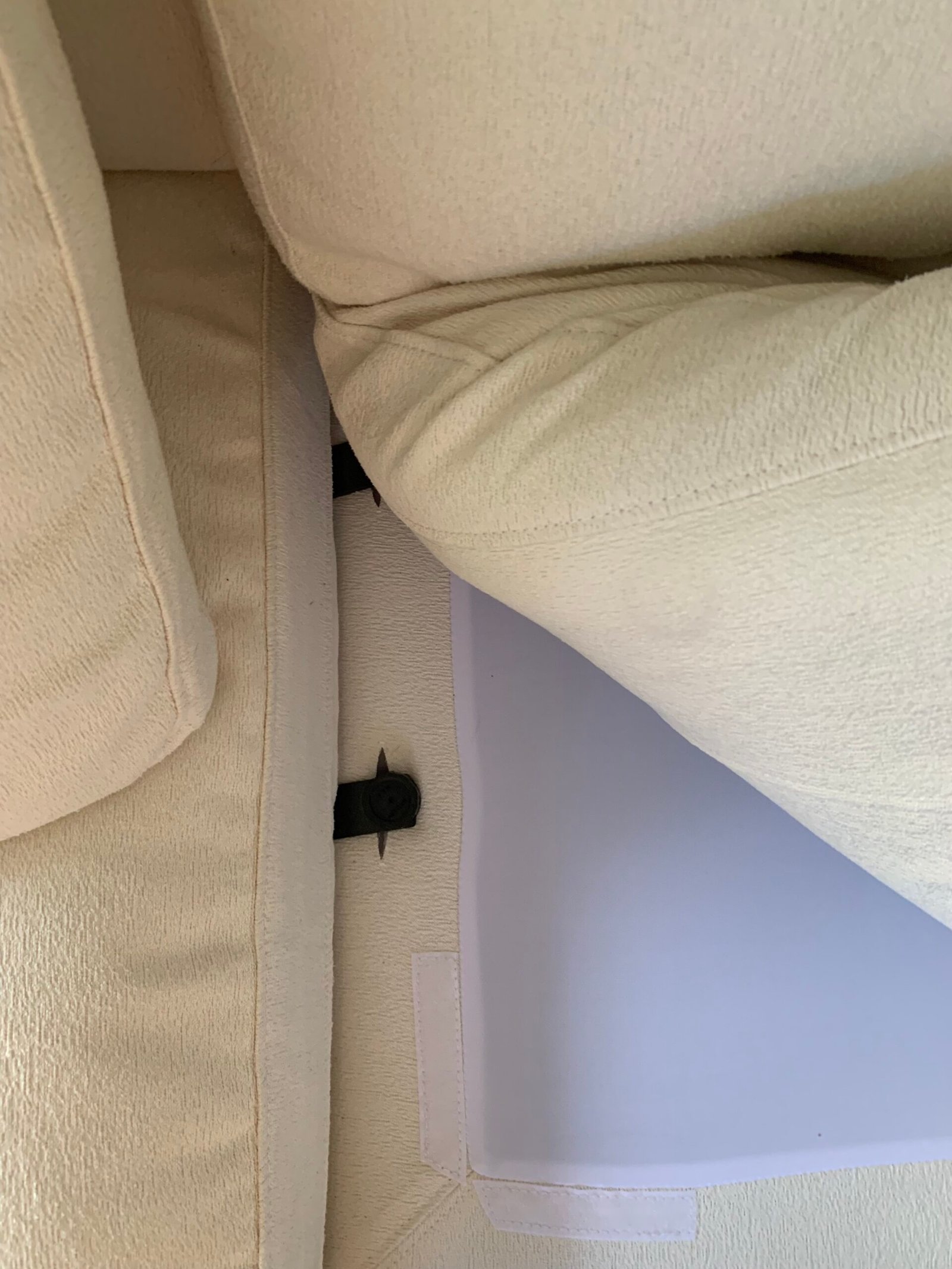 Underneath a 7th avenue couch cushion.