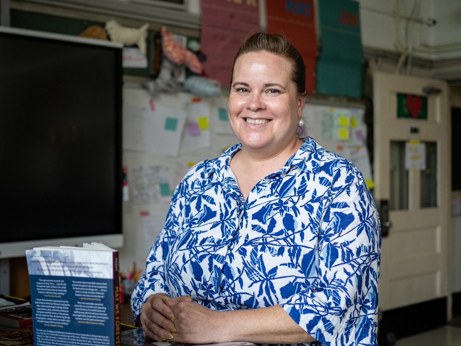 A woman stands in a classroom