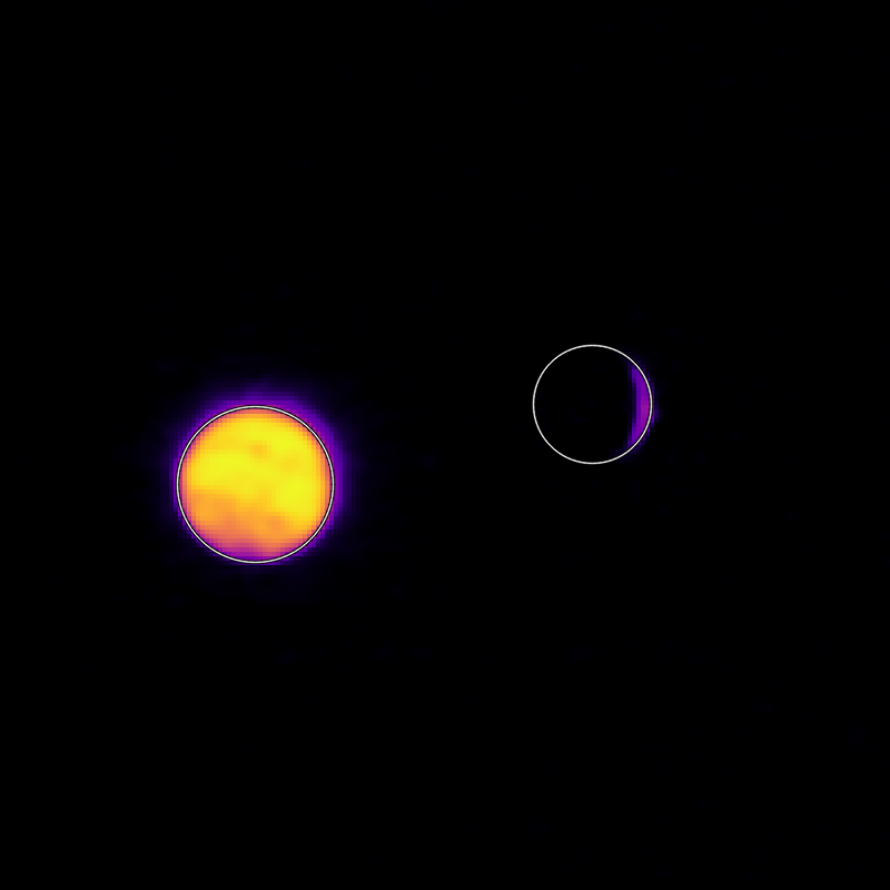 On a pitch black background sits a bright circle on the left filled with yellow, orange, and red and surrounded by a faint halo of purple. On the right, is a circle outlined with a white line, filled with black and a thin purple crescent on the right side of the circle.