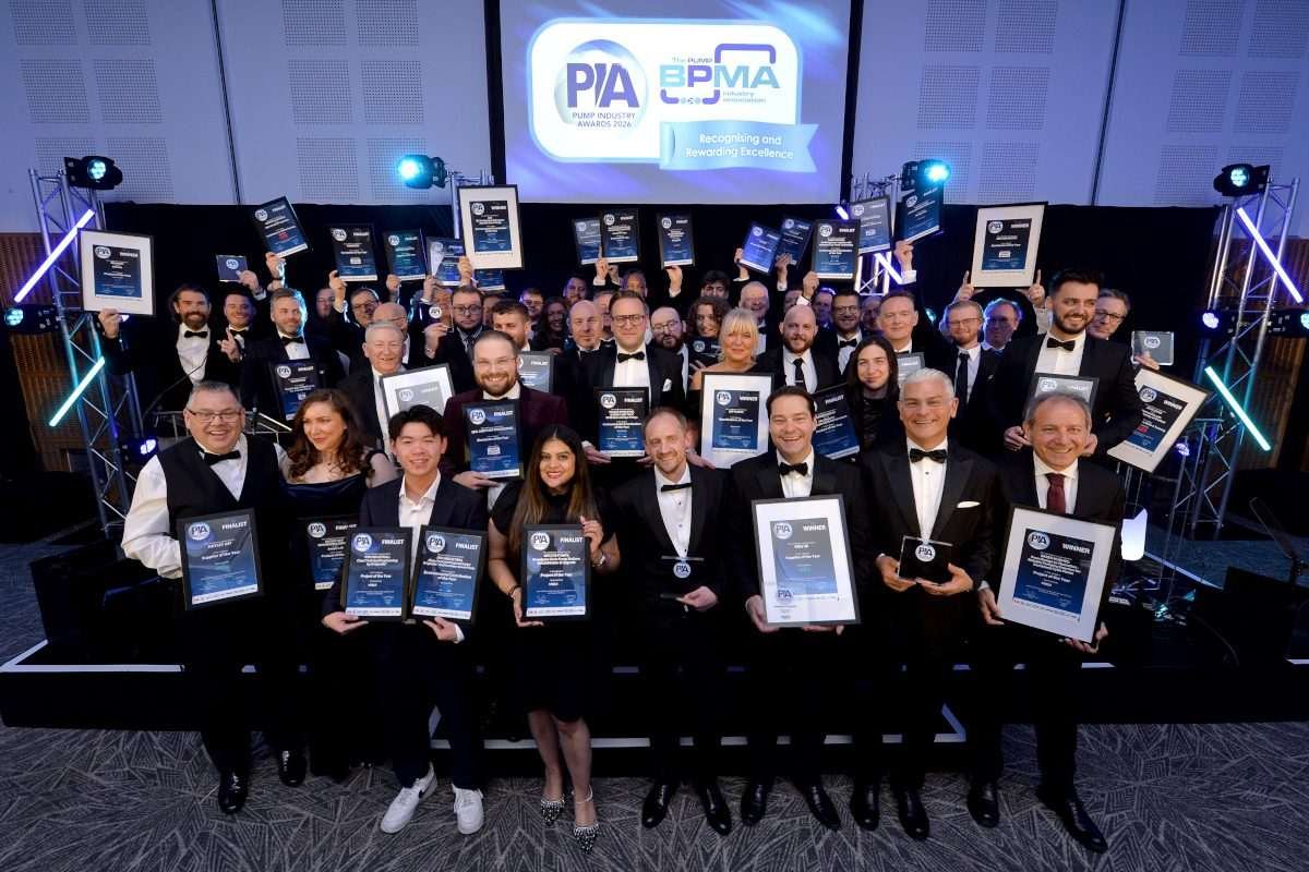 Group photograph of finalists and winners at the 2026 Pump Industry Awards, holding trophies and framed certificates during the awards ceremony