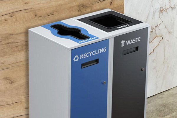 A Lounge recycling and trash bin with clearly labeled, restrictive openings that will create easy waste sorting