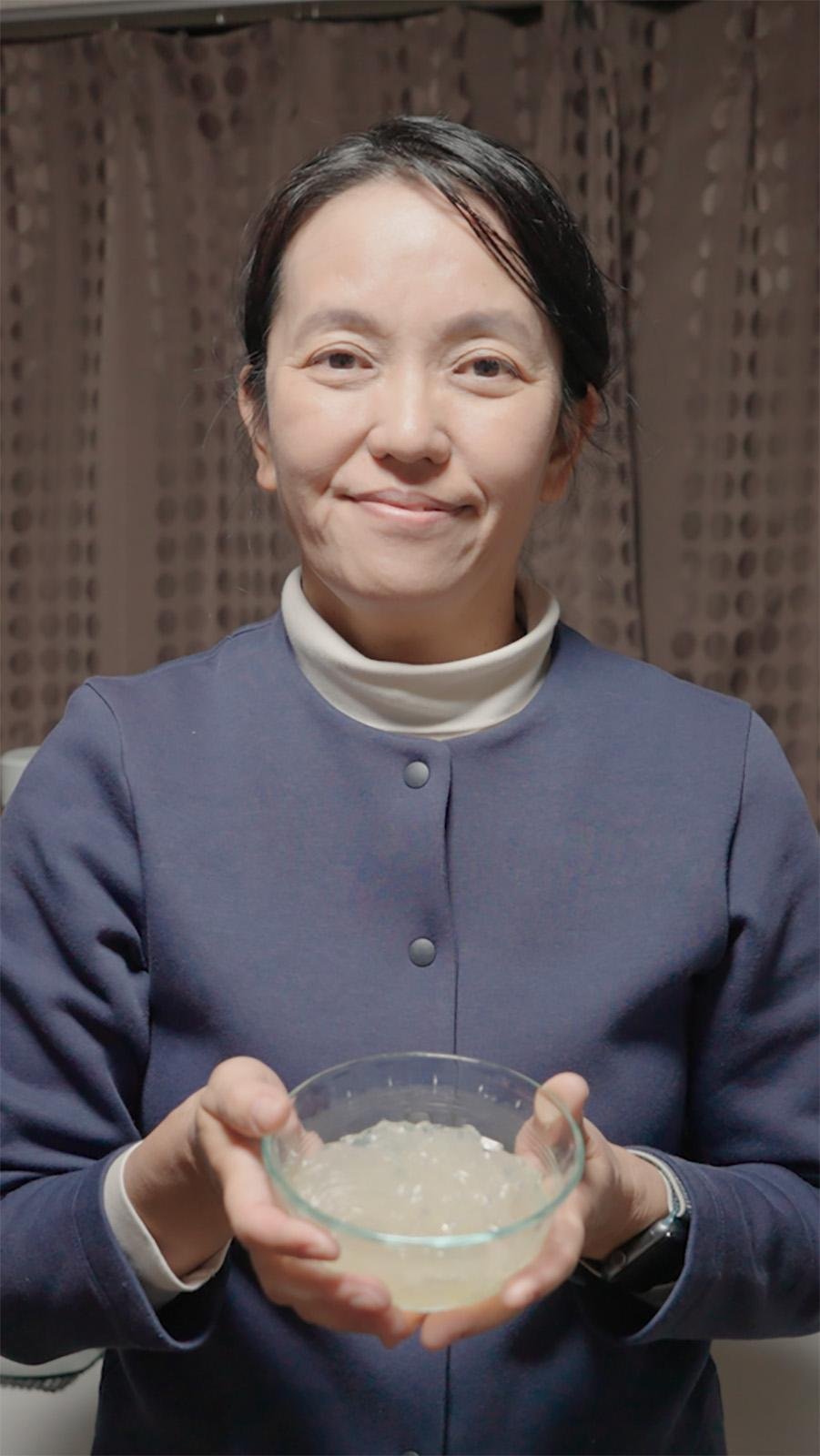 A woman holds a bowl of tokoroten noodles