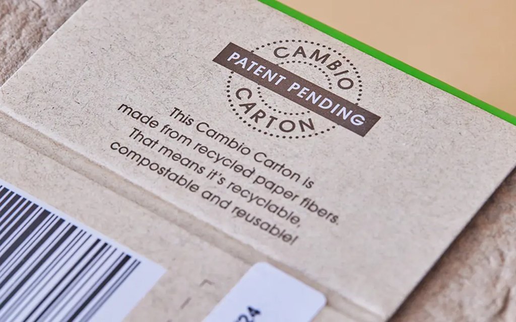 Cambio eco-friendly coffee pods in recyclable fiber-based packaging, promoting sustainability and carbon footprint reduction.
