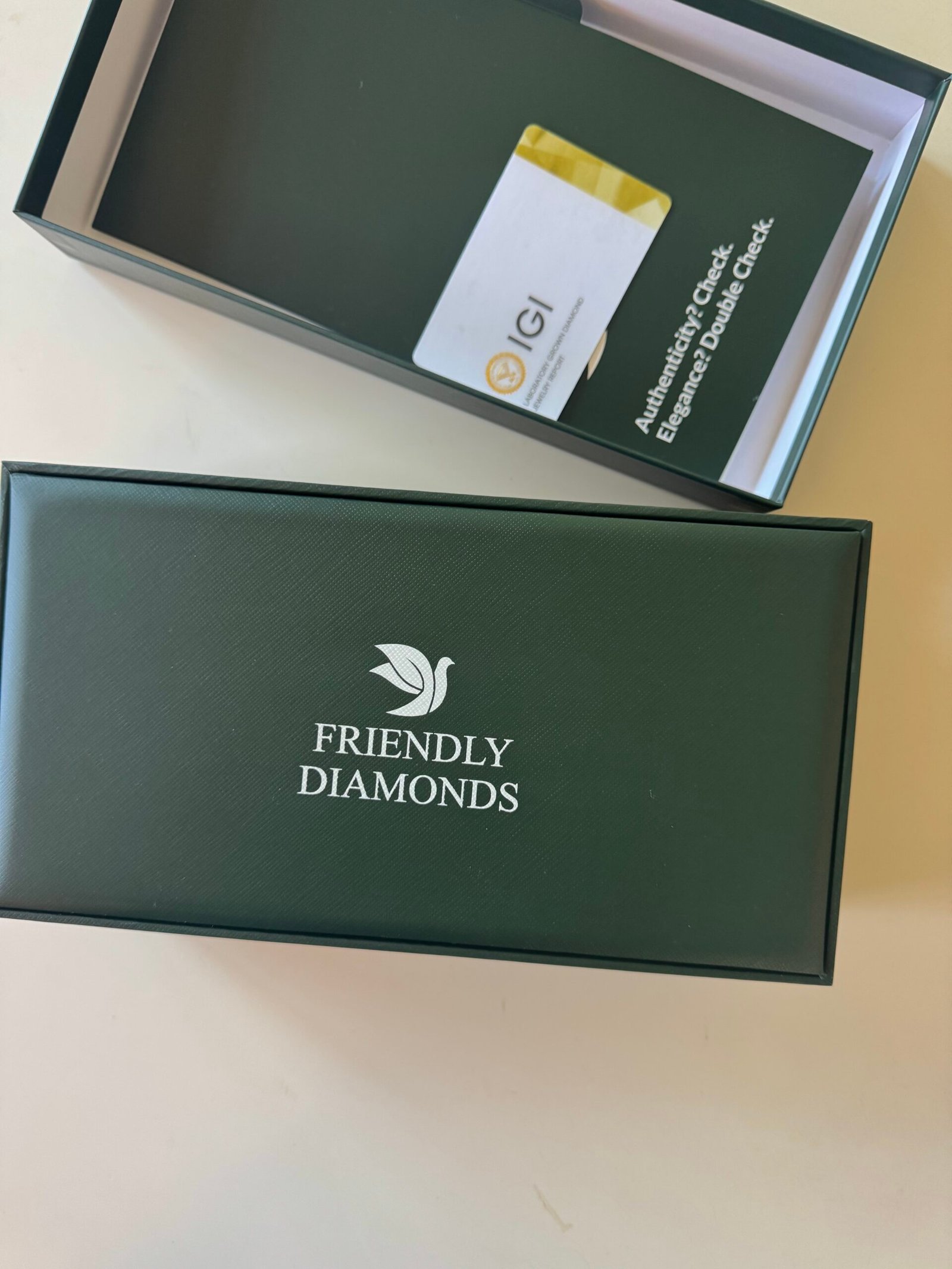 A dark green box labeled "Friendly Diamonds" sits next to its open lid, revealing a card inside the box labeled "IGI Authentication.