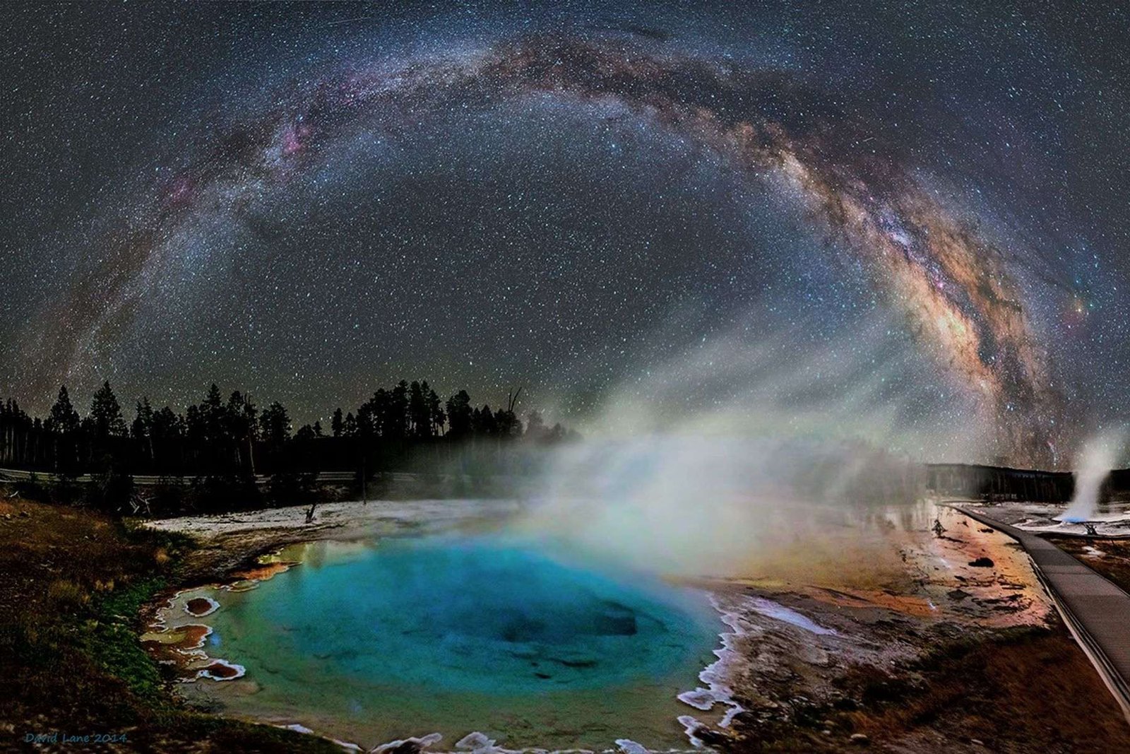 A composite image of the night sky above the old faithful guyser in Yelowstone National Park.