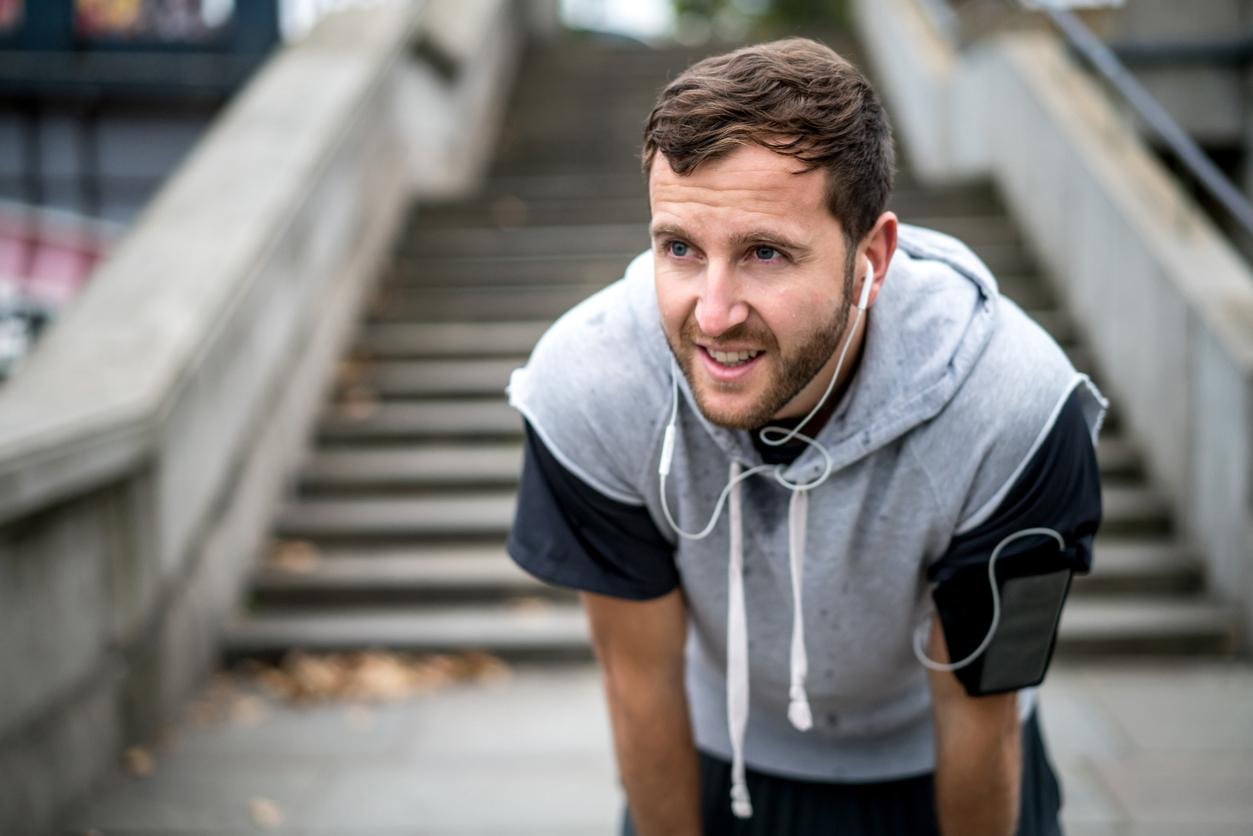 Man recovering from a run outdoors