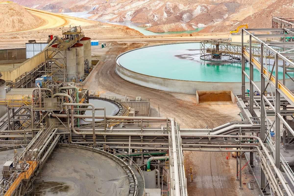 Water treatment facility with large settling tanks and pipework at a copper mine and processing plant