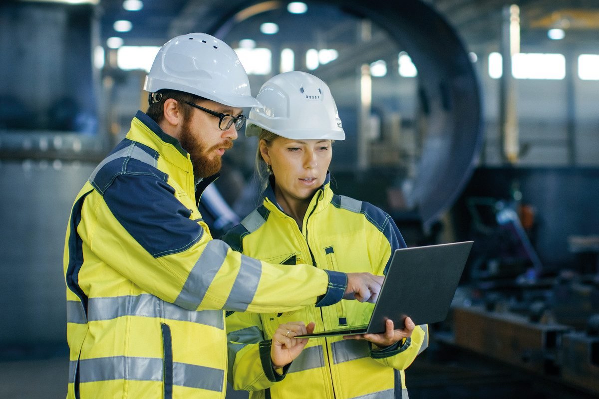 Industrial engineers looking at laptop