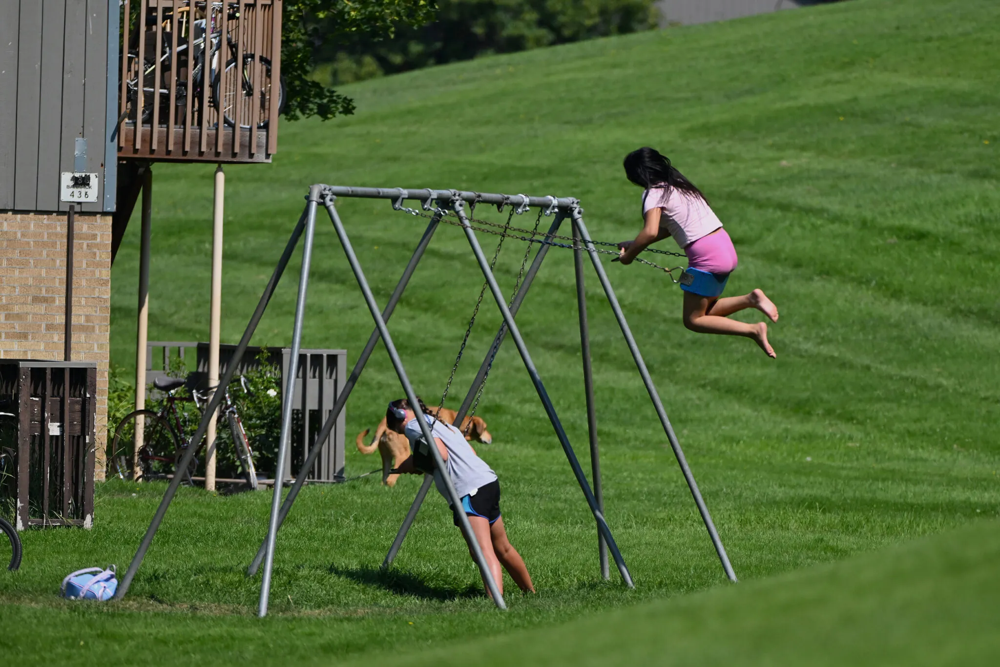 Children play on a swingset