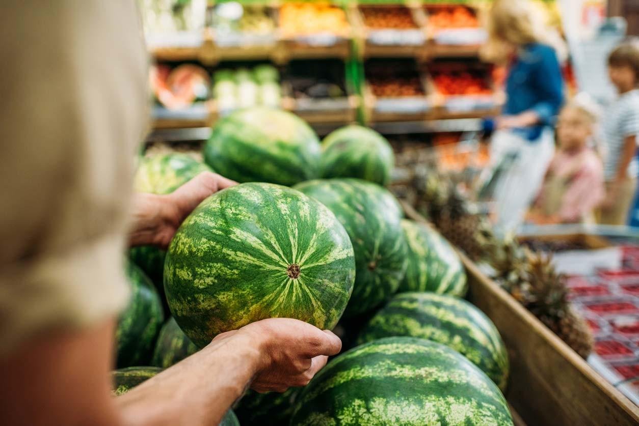 picking a watermelon at the store