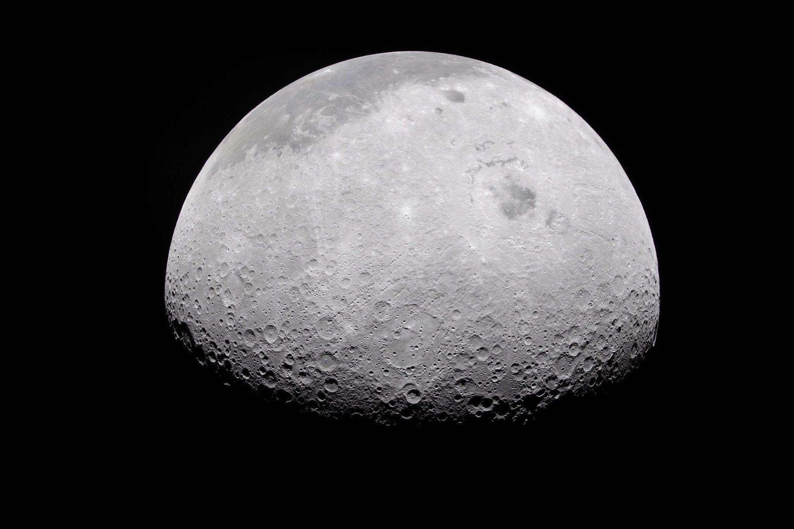 The Moon's rugged surface is on display in this image. Most of the Moon is visible, with the bottom of the sphere disappearing into the darkness. This line between light and dark is called the terminator. The terminator is lined with many craters.