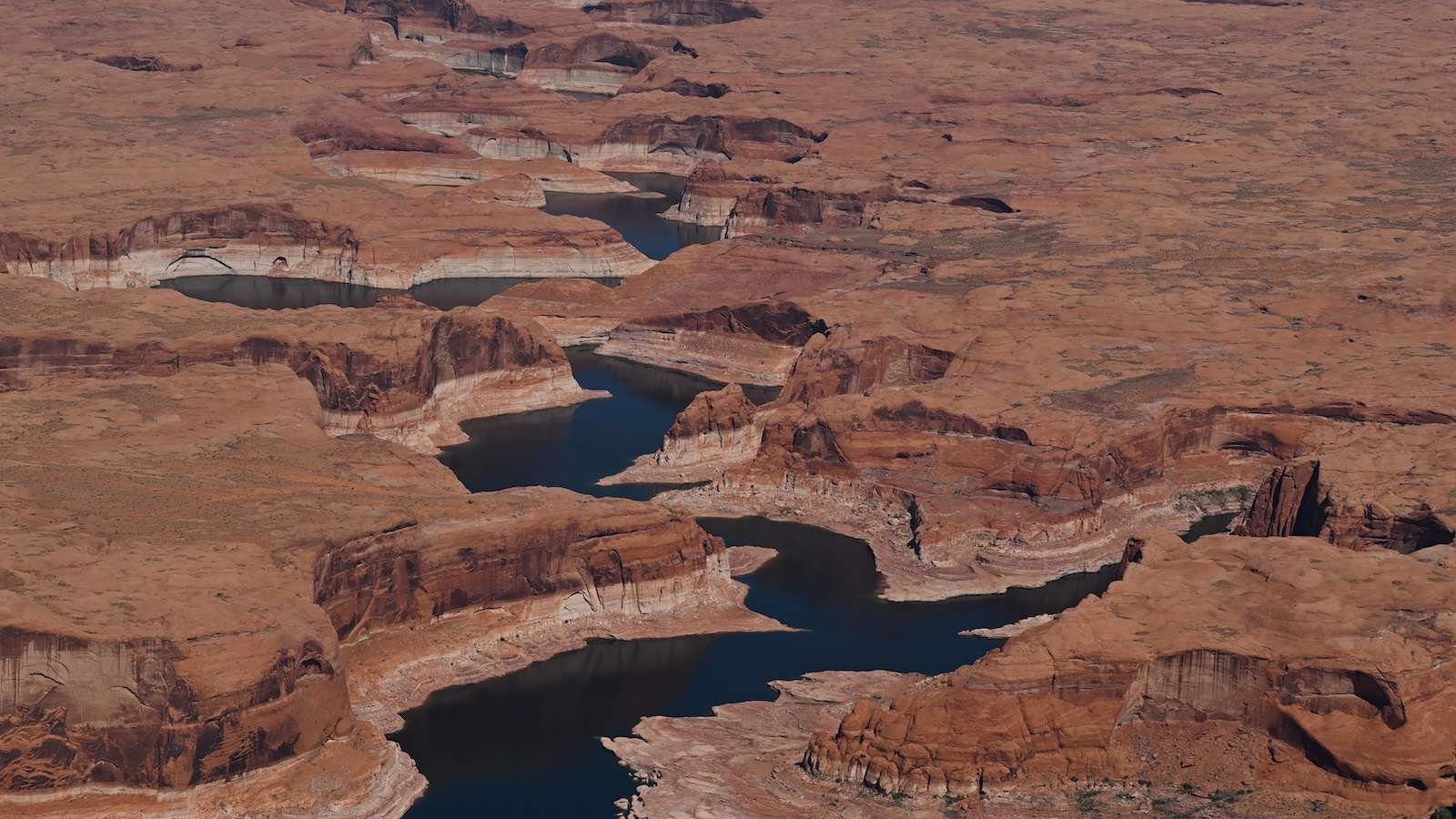 Lake Powell is shown surrounded by the rugged terrain of Utah.