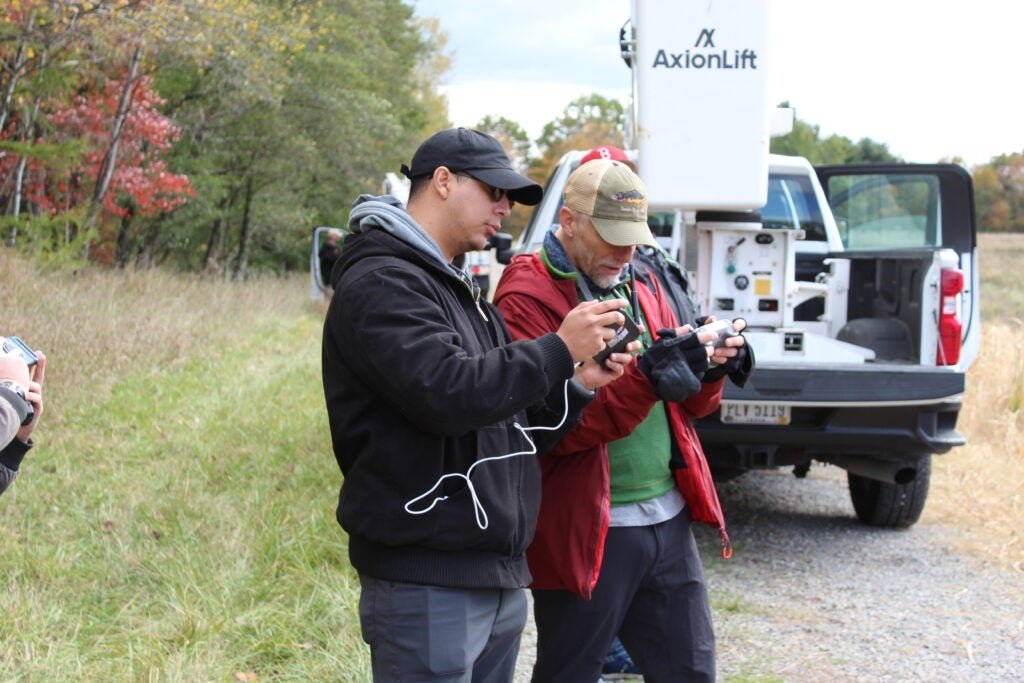 Technicians pilot a drone-mounted magnetometer.