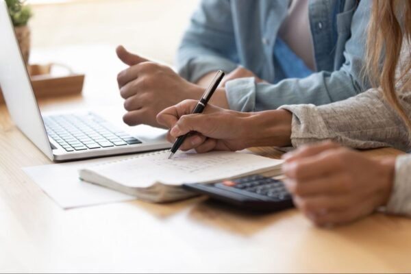 a person looking at bills holding a pen