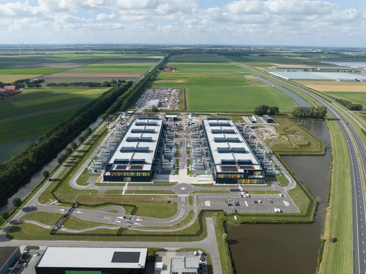Aerial view of datacentre set within flat green landscape