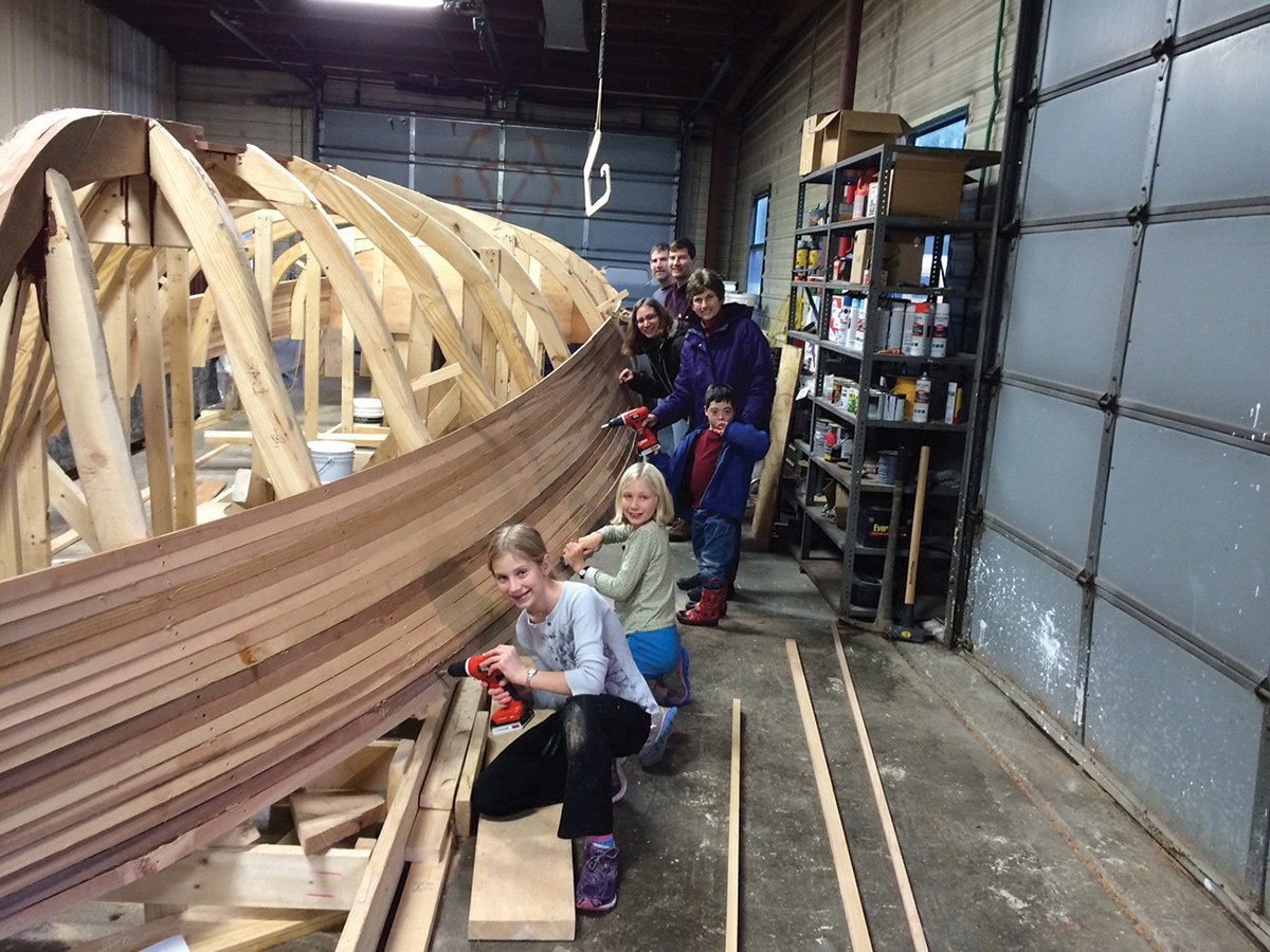 Family volunteers helping to build Solar Sal.
