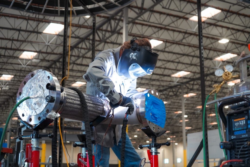 Antares lead technician Nate Jandra welds a power conversion system component in Torrance, California.