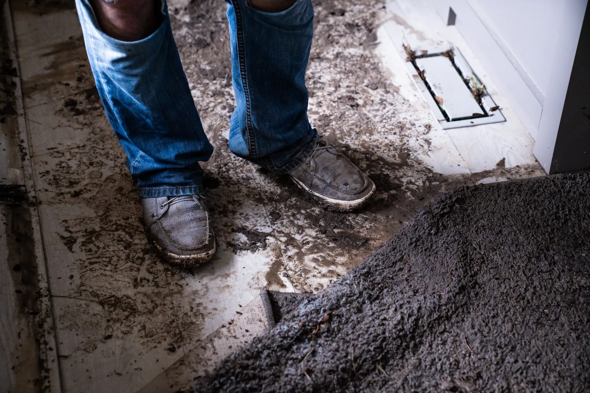 a pair of muddy shoes near an RV entrance after a flood