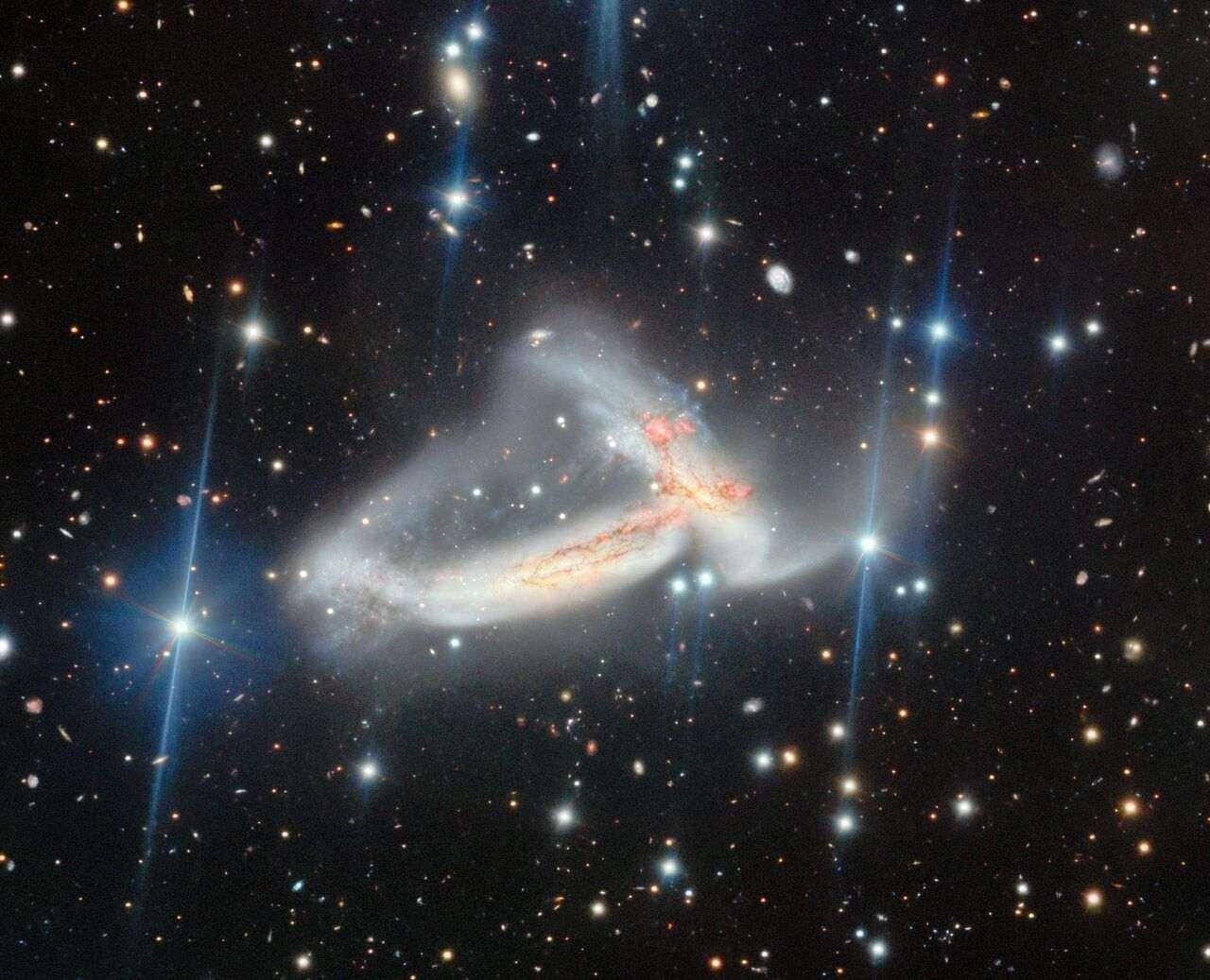 Two spiral galaxies colliding.